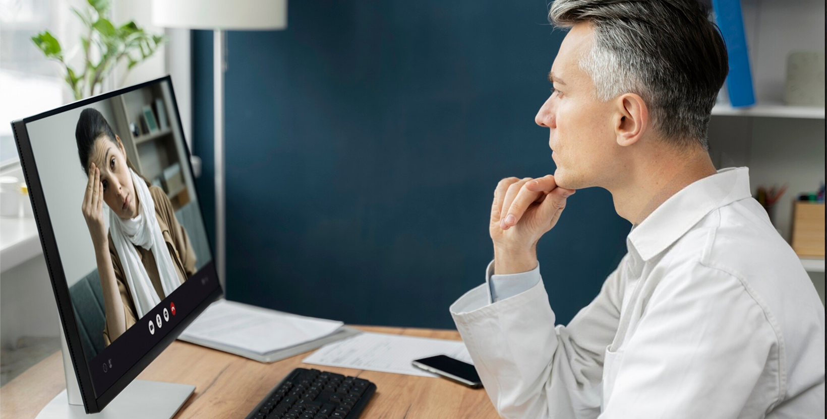 Doctor on a virtual telehealth call with a patient via laptop.