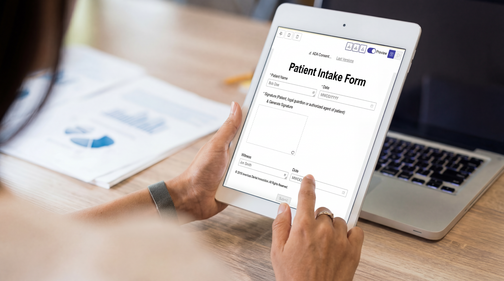 A person using a tablet to complete a digital telehealth intake form, featuring fields for patient name, date, and electronic signature on a form.